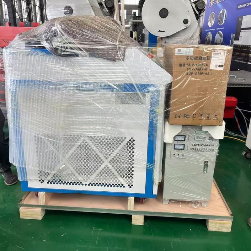 Handheld laser welding machine film-wrapped on a pallet with accessory box