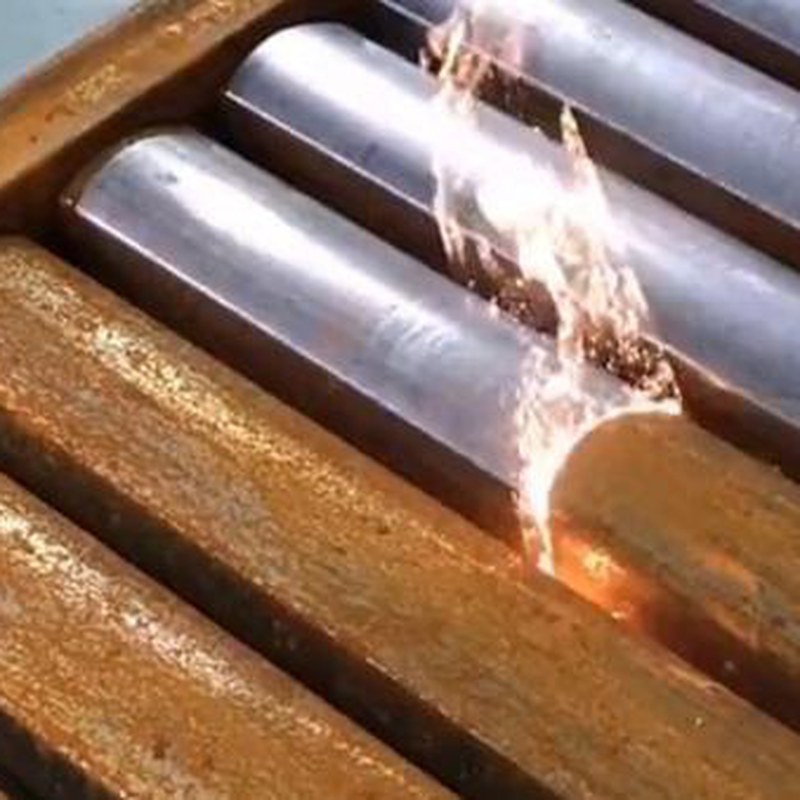 Laser cleaning rust from steel pipes in a workshop