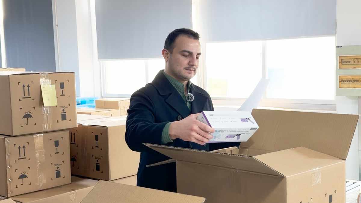 Inspector checking packed cartons on a factory floor before shipment from China
