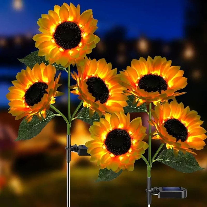 Three-head solar sunflower garden lights glowing at night